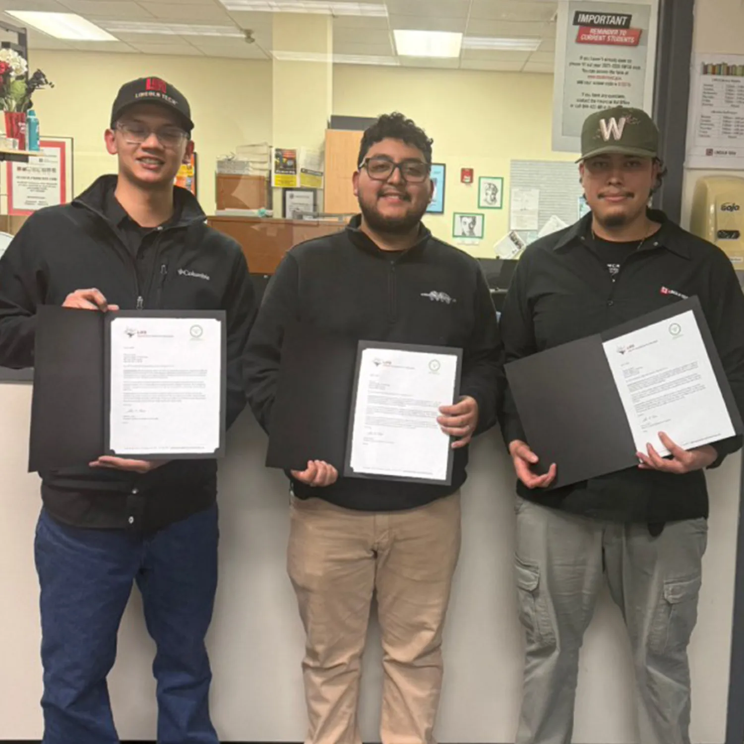 Three Lincoln Tech students holding their scholarship certificates