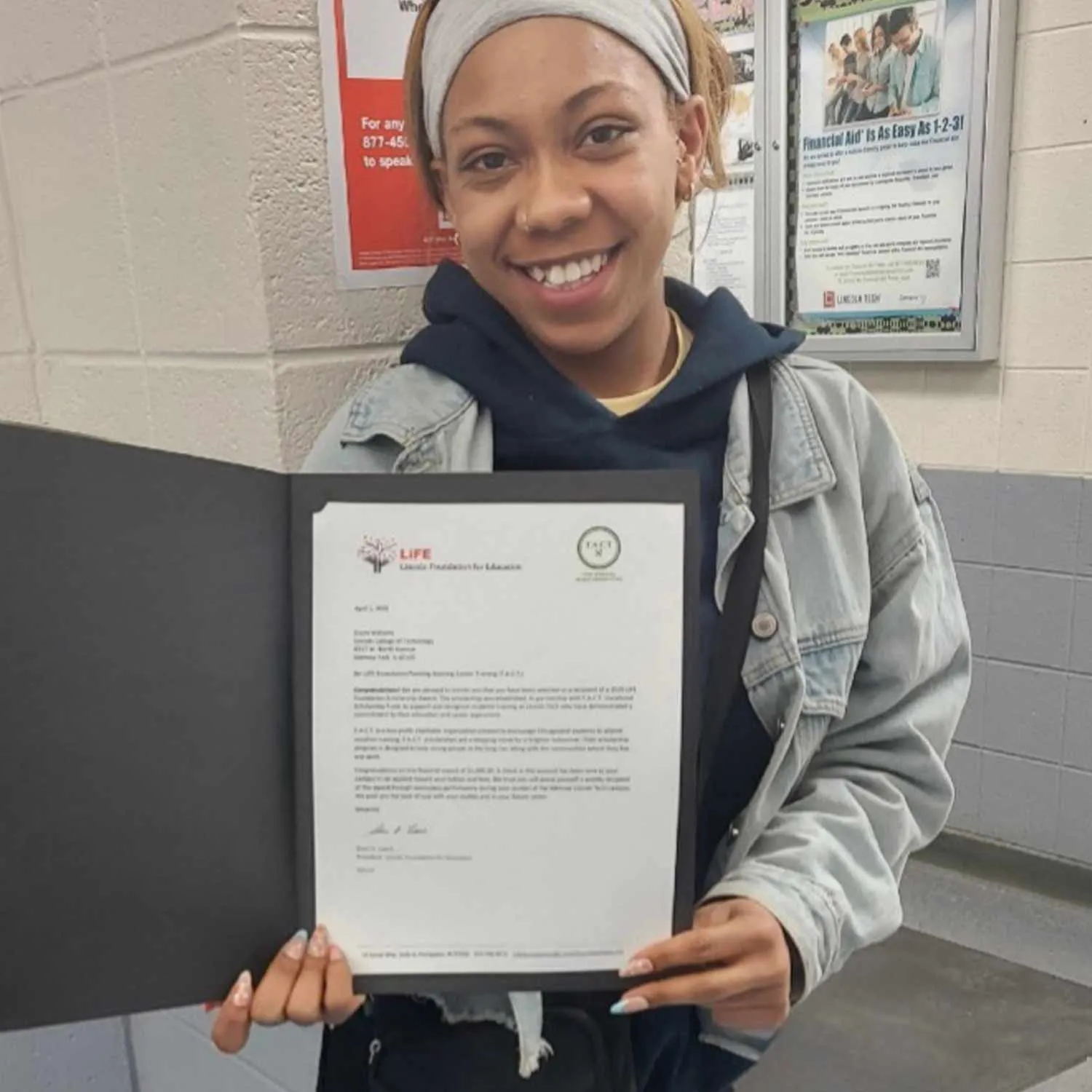 A smiling scholarship recipient holding her certificate
